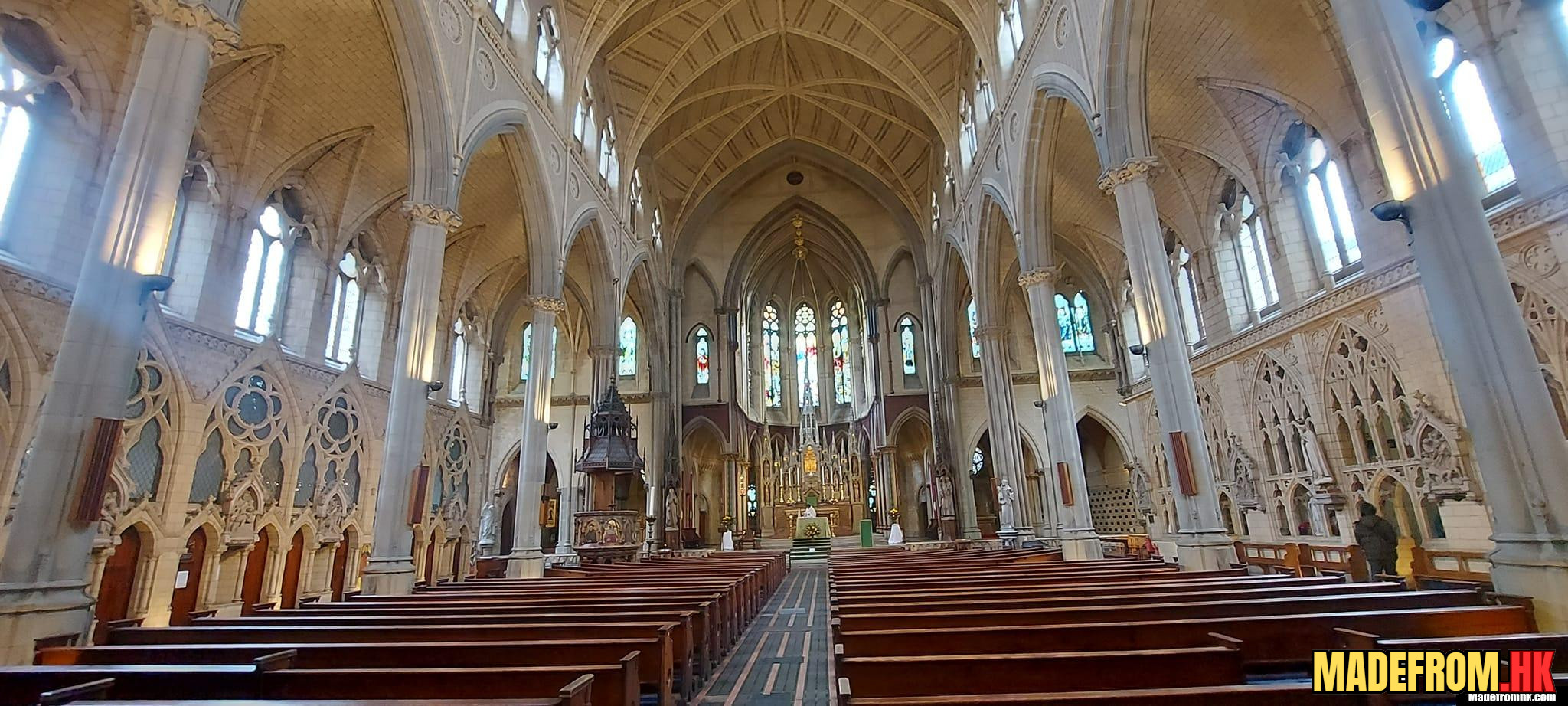 Manchester Cathedral interior with gothic wooden choir and stained glass